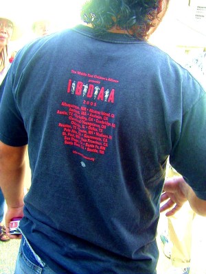 Back of blue T-shirt with IBDAA logo.